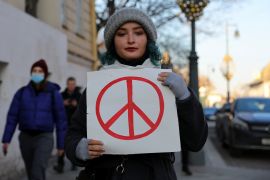A person holds a sign during a protest against Russian invasion of Ukraine in Moscow