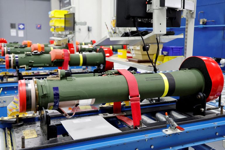 Javelin anti-tank missiles on display at a Lockheed Martin factory. The body of the missile is green.