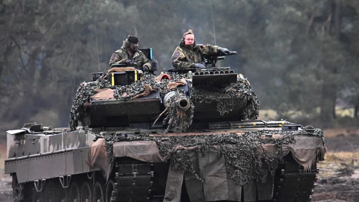 German Defense Minister Boris Pistorius rides a tank as he visits the Leopard II tanks that are due to be supplied to Ukraine at the tank brigade Lipperland of Germany's army and part of the Bundeswehr