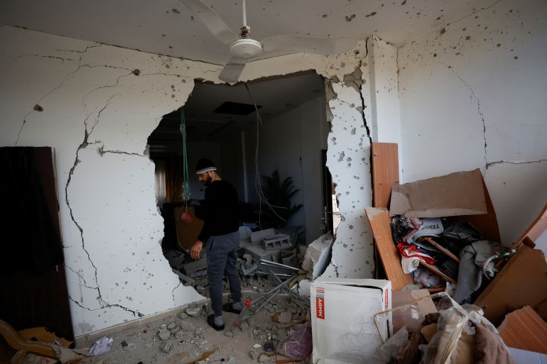 A Palestinian man checks damage in a house which was destroyed by Israeli troops during a military raid in Jericho.