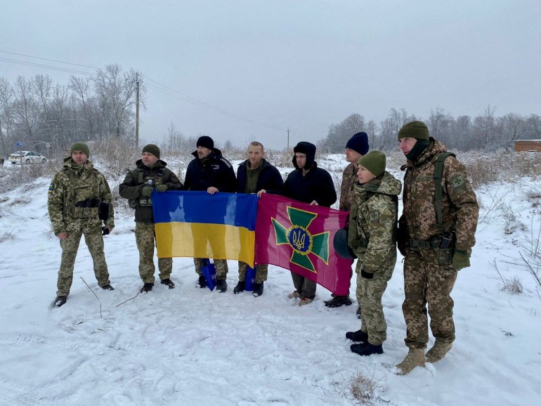 POWs of Ukraine (POW) pose for a photo after their swap, amid Russia's attack on Ukraine, at an unspecified location, Ukraine, in this documentary photo released February 4, 2023. Press Service of the General Staff of the Armed Forces of Ukraine/ Release via REUTERS EDITORS ATTENTION - THIS IMAGE IS SUPPLIED A THIRD PARTY.  REFILE - EDIT YEARS
