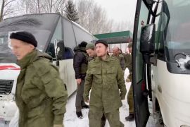 A still image from video, released by Russia&#39;s defence ministry on February 4, 2023, shows what it described as captured Russian service personnel leaving a bus following the latest prisoner exchange [Russian Defence Ministry/Handout via Reuters]
