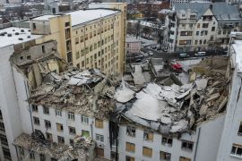 A bird's eye view shows a building of the National University of Urban Economy heavily damaged by a Russian missile, amid Russia's attack on Ukraine, in central Kharkiv, Ukraine. The multistoried building's top floors are crumpled in a mass of debris.