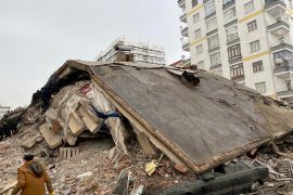 People search through rubble following an earthquake in Diyarbakir, Turkey, February 6, 2023 [Sertac Kayar/Reuters]