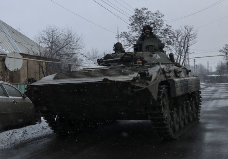 Ukrainian service members ride a BMP-2 infantry fighting vehicle, as Russia's attack on Ukraine continues, near the frontline town of Bakhmut, Donetsk region