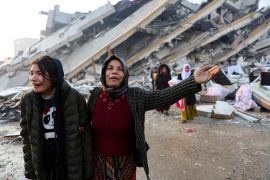 Women reacts near the rubble of a building in Hatay, Turkey. [Umit Bektas/Reuters]