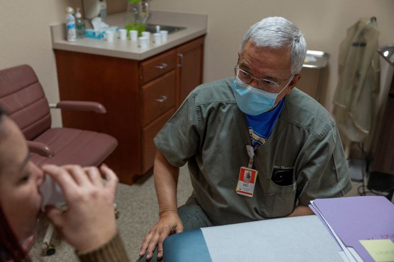 A doctor watches a patient take an abortion pill at a clinic