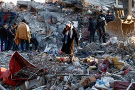 A woman looks at the destruction in Kahramanmaras, Turkey [Suhaib Salem/Reuters]