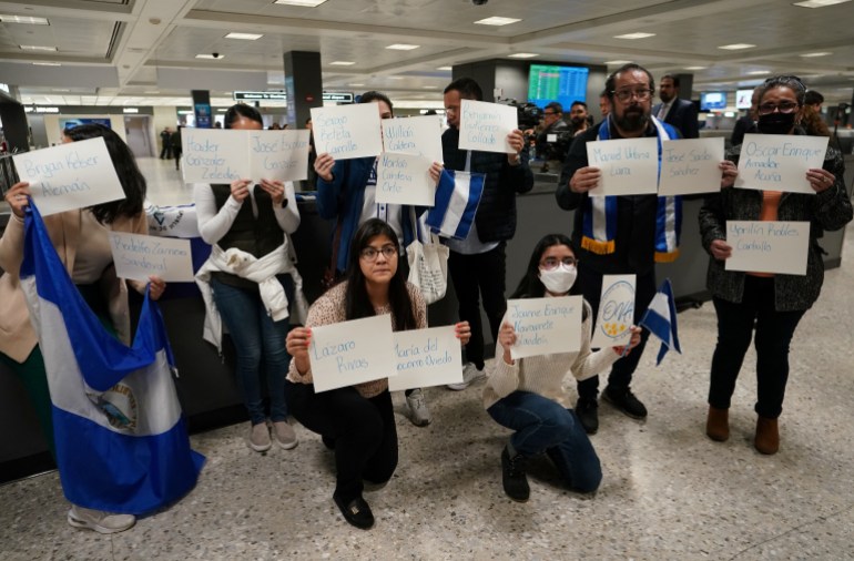 Activists hold up signs with names of some of the opposition figures released from prison in Nicaragua and flown to the US