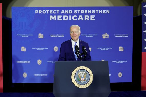Biden stands at a podium before a banner that reads "Protect and strengthen Medicare"