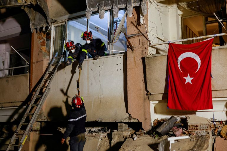 Members of French search and rescue team work at a damaged building in the aftermath of a deadly earthquake in Hatay, Turkey.