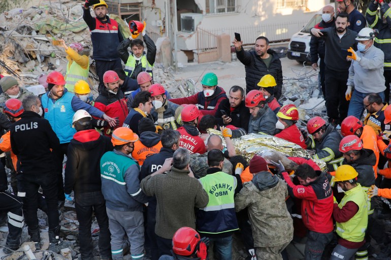Rescuers carry Kaan, a 13-year-old Turkish teenager, to an ambulance after he was pulled from the rubble after 182 hours, following a deadly earthquake in Hatay, Turkey, February 13, 2023. REUTERS/Dilara Senkaya