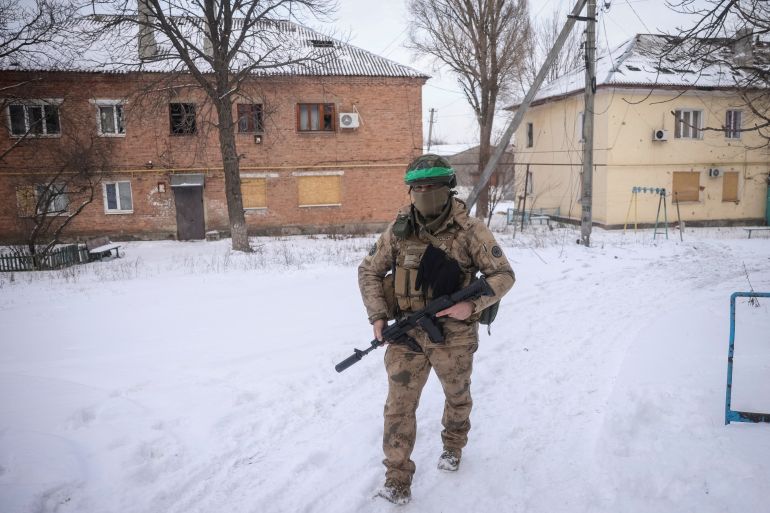 A Ukrainian serviceman walks on an empty street, as Russia's attack on Ukraine continues, in the front line city of Bakhmut, Ukraine