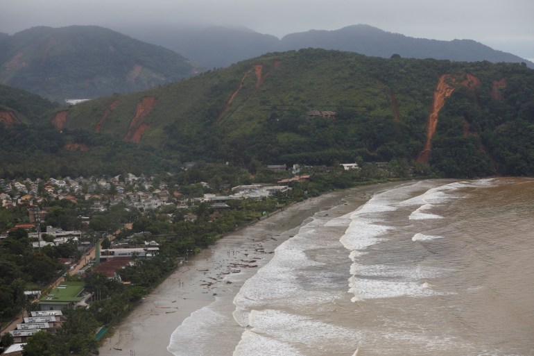 Landslides are visible on the side of a hill in San Sebastiao
