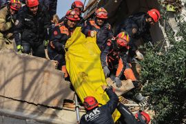 Rescuers carry a dead body, in the aftermath of the latest earthquake in Hatay province,Turkey February 21, 2023.