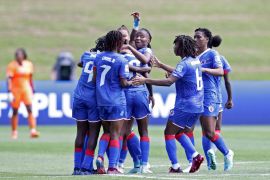Haiti's Nerilia Mondesir celebrates scoring their second goal with teammates