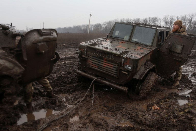 Ukrainian military personnel next to an armored vehicle near the frontline town of Bakhmut during a Russian attack on Ukraine on February 25, 2023 in the Donetsk region of Ukraine.  REUTERS/Yan Dobronosov