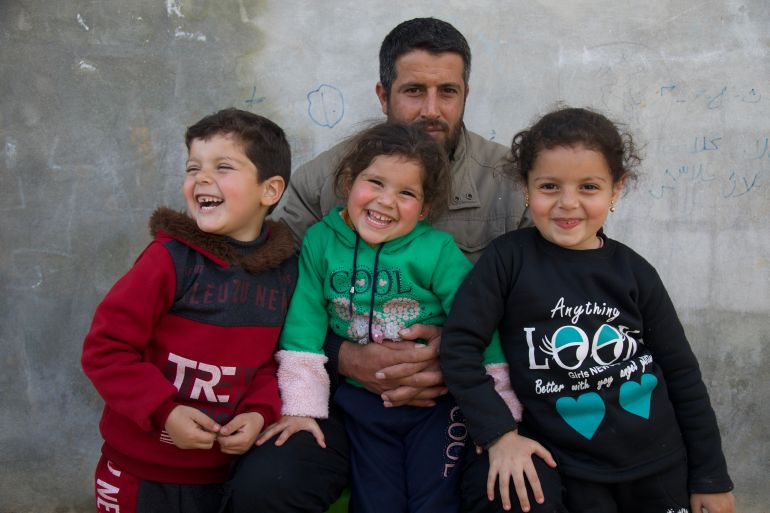 Mustafa al-Sayed poses with his three children