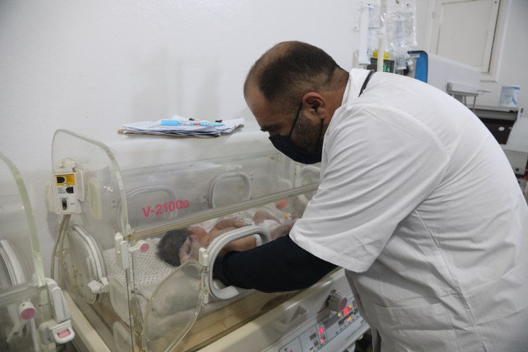 Dr. Maarouf reached into the incubator to check on baby Aya