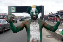 A supporter wears national green and white colours to campaign for candidate of Labour Party Peter Obi
