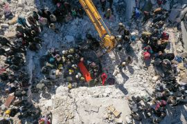 An aerial picture shows rescuers searching the rubble of buildings for casualties and survivors in the village of Salqin in Syria&#39;s rebel-held northwestern Idlib province at the border with Turkey [Omar Haj Kadour/AFP]