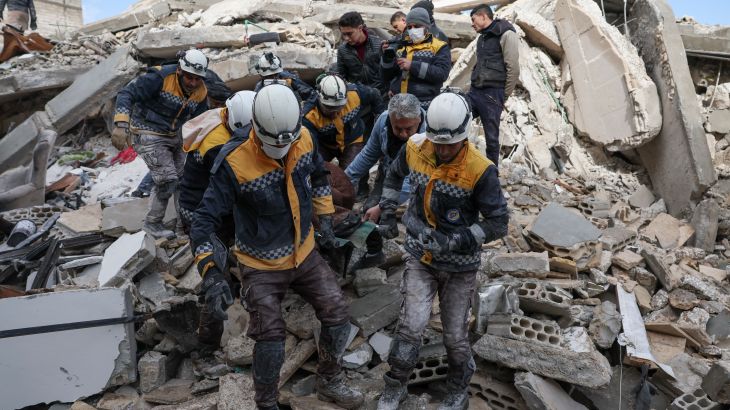 Members of the Syrian civil defence, known as the White Helmets, transport a casualty from the rubble of buildings in the village of Azmarin in Syria's rebel-held northwestern Idlib province