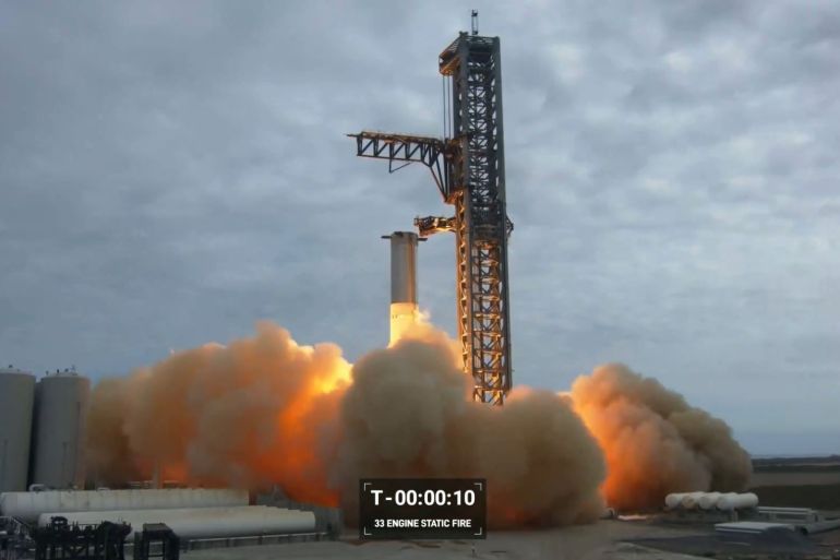 This frame grab from a video provided by SpaceX shows a test-firing on February 9, 2023 of the massive engines on the most powerful rocket ever built, designed to send astronauts to the Moon and beyond, at a SpoaceX base in Boca Chica, Texas. - The test, called a static fire, of the 33 Raptor engines on the first-stage booster of Starship took place at a SpaceX base in Texas. (Photo by Nicholas KAMM / SPACEX / AFP) / RESTRICTED TO EDITORIAL USE - MANDATORY CREDIT "AFP PHOTO / SPACEX" - NO MARKETING NO ADVERTISING CAMPAIGNS - DISTRIBUTED AS A SERVICE TO CLIENTS - RESTRICTED TO EDITORIAL USE - MANDATORY CREDIT "AFP PHOTO / SPACEX" - NO MARKETING NO ADVERTISING CAMPAIGNS - DISTRIBUTED AS A SERVICE TO CLIENTS /
