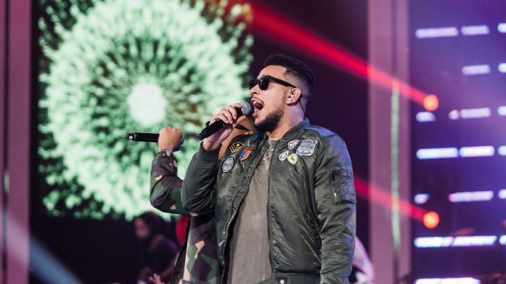 South African rapper AKA sings on stage.