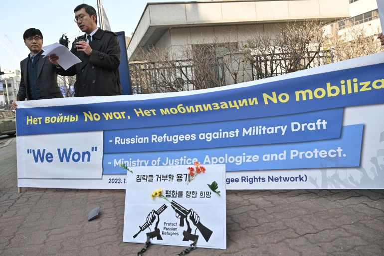 South Korean attorneys Lee Jong-chan (L) and Lee Il (2nd L), who represent Russian asylum seekers stranded at Incheon International Airport, speak to reporters outside the district court in Incheon on February 14, 2023. - A South Korean court on February 14 granted two Russian asylum seekers who have been stranded at Incheon airport for months right to apply for refugee status, allowing them to enter the country. (Photo by Jung Yeon-je / AFP)