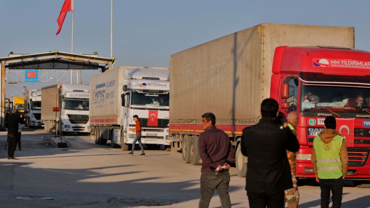 Trucks part of an aid convoy cross from Turkey into rebel-held north Syria through the Bab al-Salama crossing