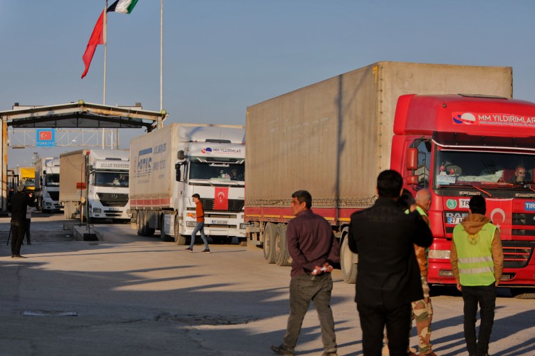 Trucks part of an aid convoy cross from Turkey into Syria