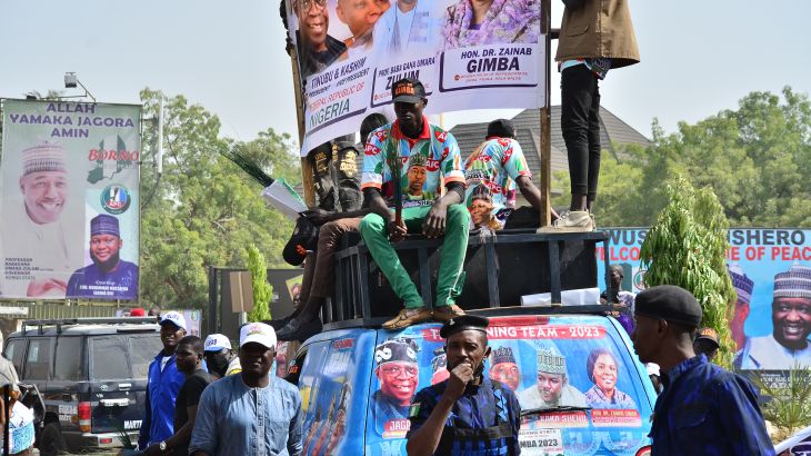 Supporters sit on a vehicle during an All progressives Congress (APC) rally in Maiduguri on February