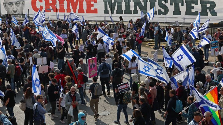 People gather with Israeli flags during a protest against the government's judicial reform bill near the Knesset (parliament) in Jerusalem on February 20, 2023.
