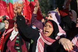 Palestinians take part in a march to denounce the Israeli military's deadly raid in Nablus