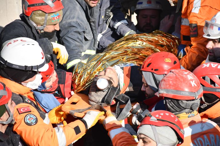 KAHRAMANMARAS, TURKIYE - FEBRUARY 14: 17-year-old Muhammed Enes Yeninar is rescued along with his 21-year-old brother Abdulbaki Yeninar (not seen) by search and rescue teams from under rubble of a collapsed building 198 hours after 7.7 and 7.6 magnitude earthquakes hit Turkiye's Kahramanmaras, on February 14, 2023. On Feb. 06, a strong 7.7 earthquake, centered in the Pazarcik district, jolted Kahramanmaras and strongly shook several provinces, including Gaziantep, Sanliurfa, Diyarbakir, Adana, Adiyaman, Malatya, Osmaniye, Hatay, and Kilis. Later, at 13.24 p.m. (1024GMT), a 7.6 magnitude quake centered in Kahramanmaras' Elbistan district struck the region. ( Mehmet Taha Mazı - Anadolu Agency )