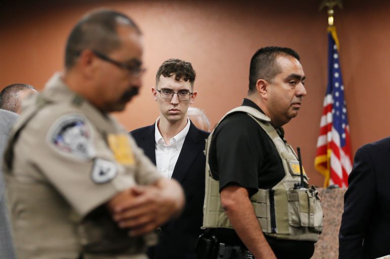 Patrick Crusius in court, surrounded by law enforcement