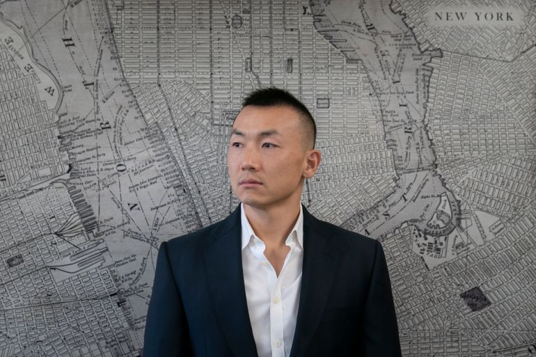 A portrait of Baimadajie Angwang before a map of New York City