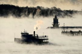 Arctic sea smoke rises from the the Atlantic Ocean as a passenger ferry passes Spring Point Ledge Light, off the coast of South Portland, Maine. [Robert F Bukaty/AP Photo]