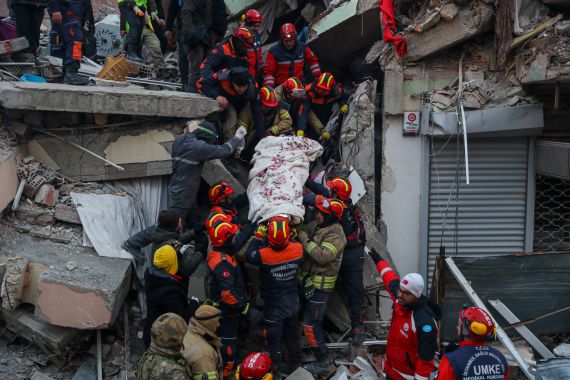 Turkish rescue workers carry Ergin Guzeloglan, 36,