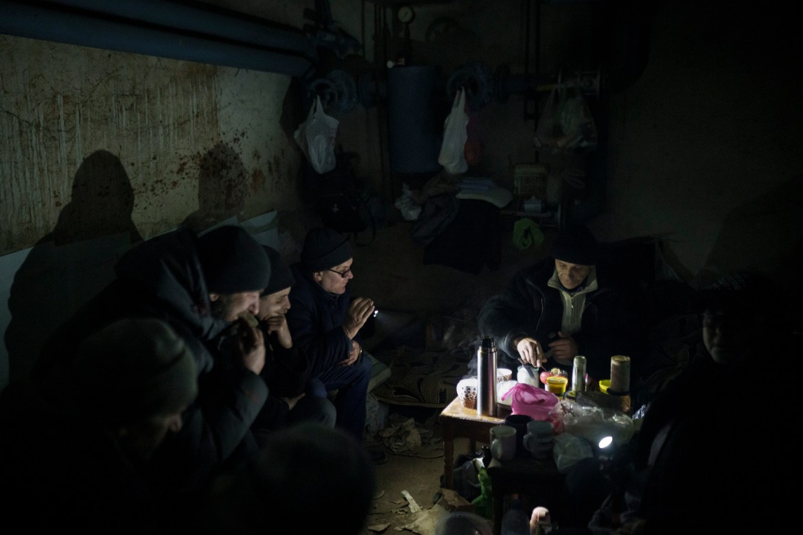 Residents prepare tea in a basement being used as a bomb shelter in Irpin