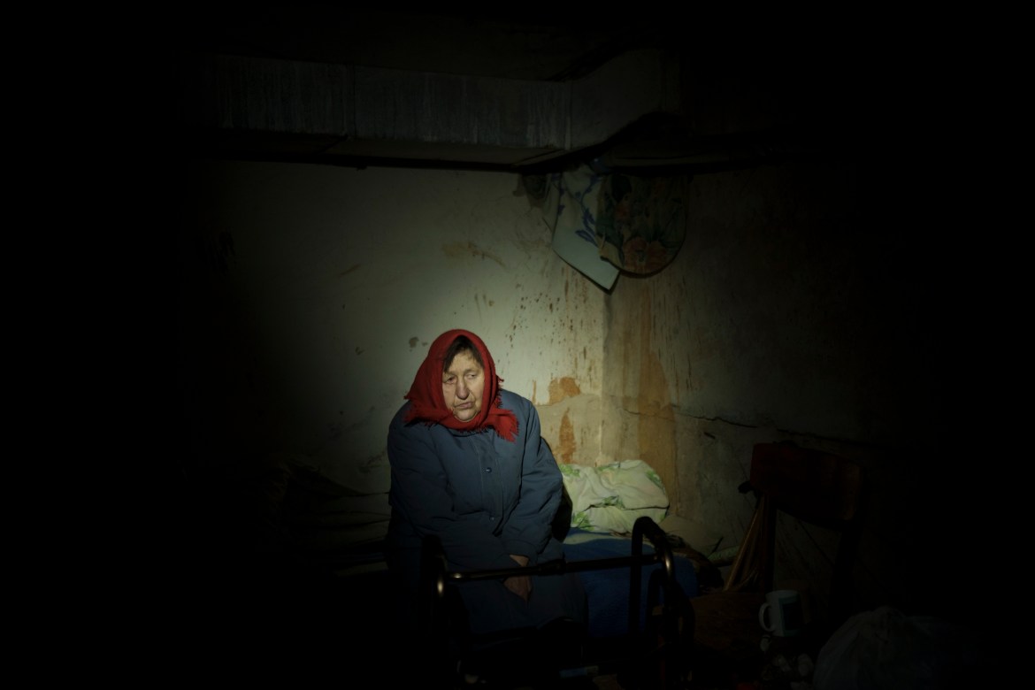 A woman takes shelter in a basement with no electricity in Irpin, on the outskirts of Kyiv