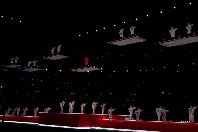 Rihanna and her dancers suspended above the stage on separate platforms.
