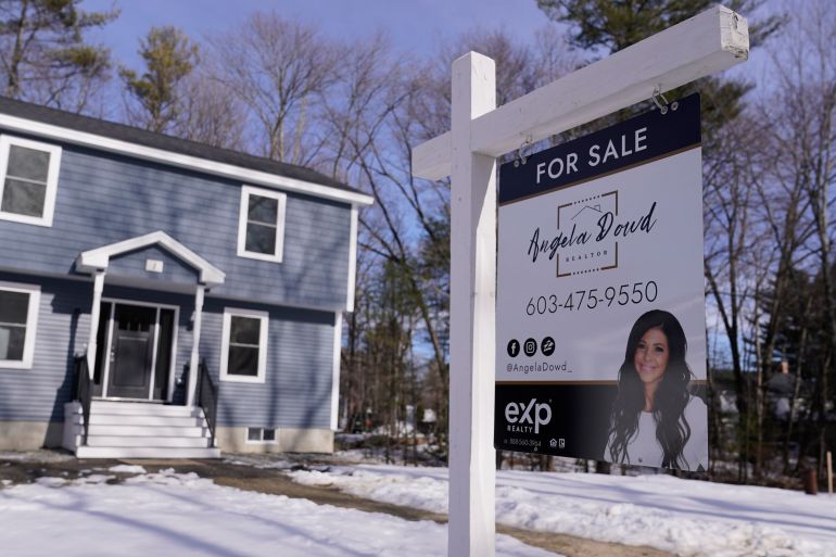 A "For Sale" sign is posted outside a single family home in Derry, NH, US