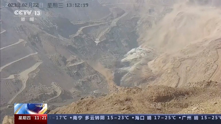 In this image taken from official surveillance camera footage run by China's CCTV, dirt moves down the side of a hill at an open pit mine in Alxa League