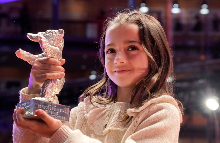 Young Actress Sofia Otero holds up the Silver Bear she received for Best Acting Performance in a Leading Role in the film "20.000 species of bees".