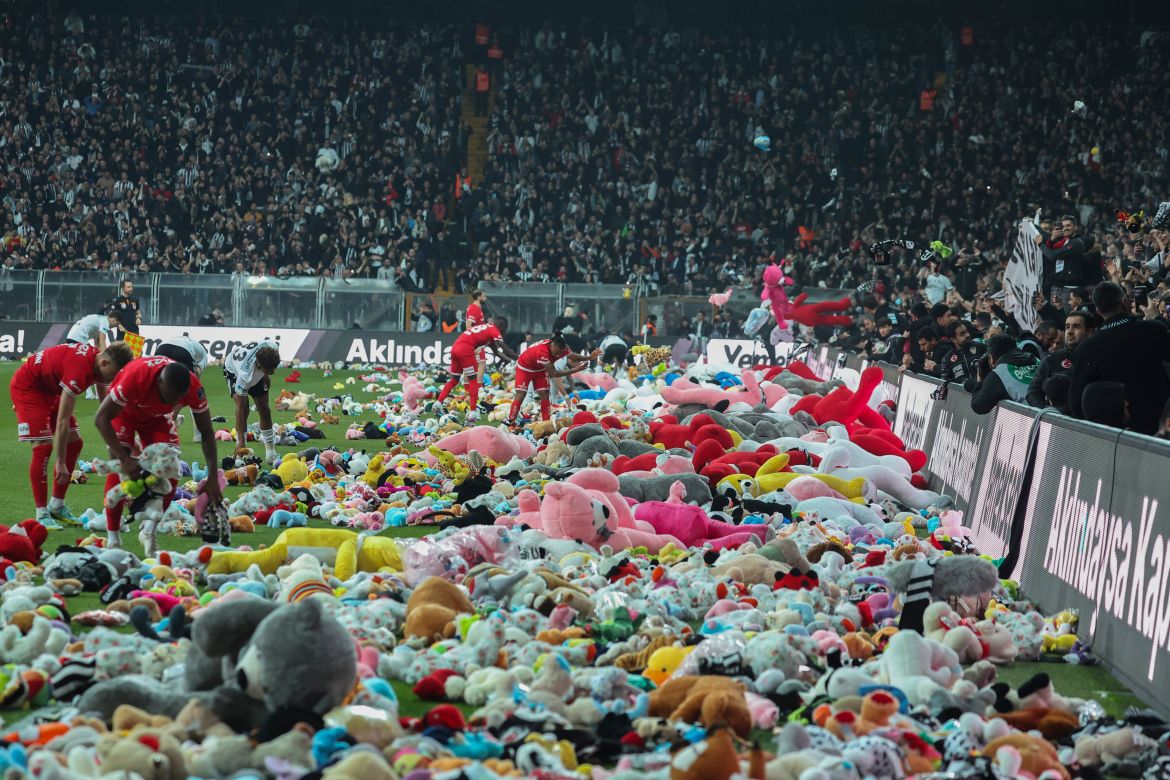 Fans throw toys onto the pitch during the Turkish Super League football match