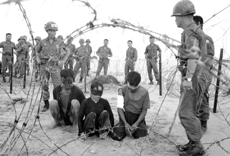 South Korean troops of the White Horse Division with three Vietnamese prisoners in 1966 [File: Hong/AP Photo]