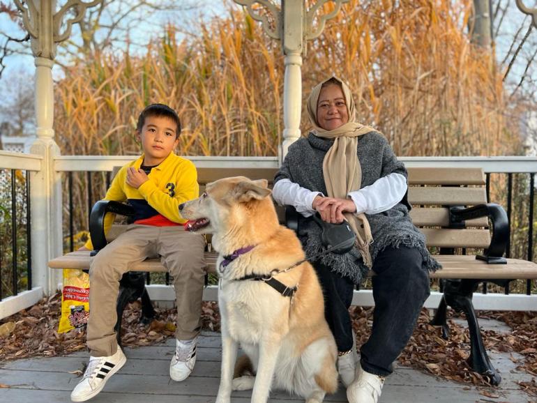 A photo of Aqila and Ali with Ash, Brennan's dog in Toronto