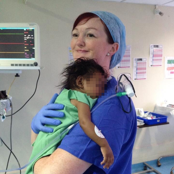 A nurse holds a baby