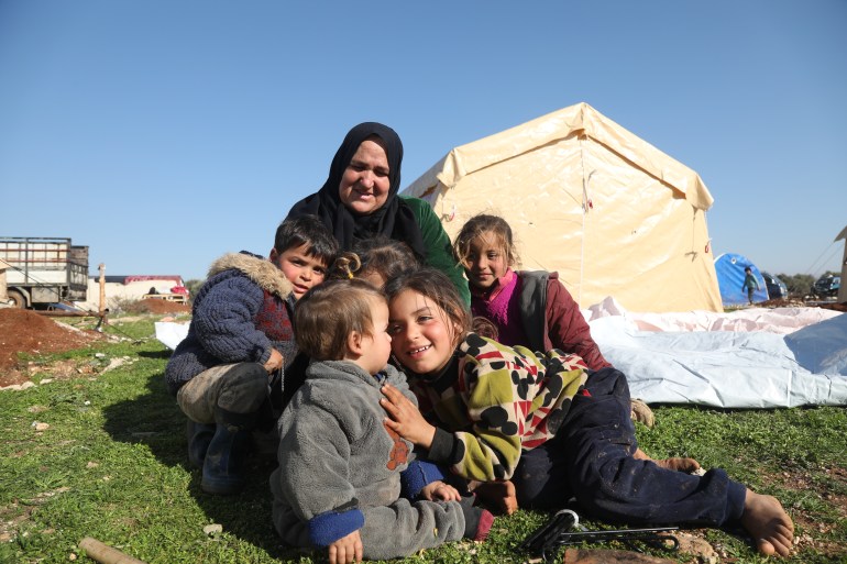 Samaher Rashid with her kids in front of their tent